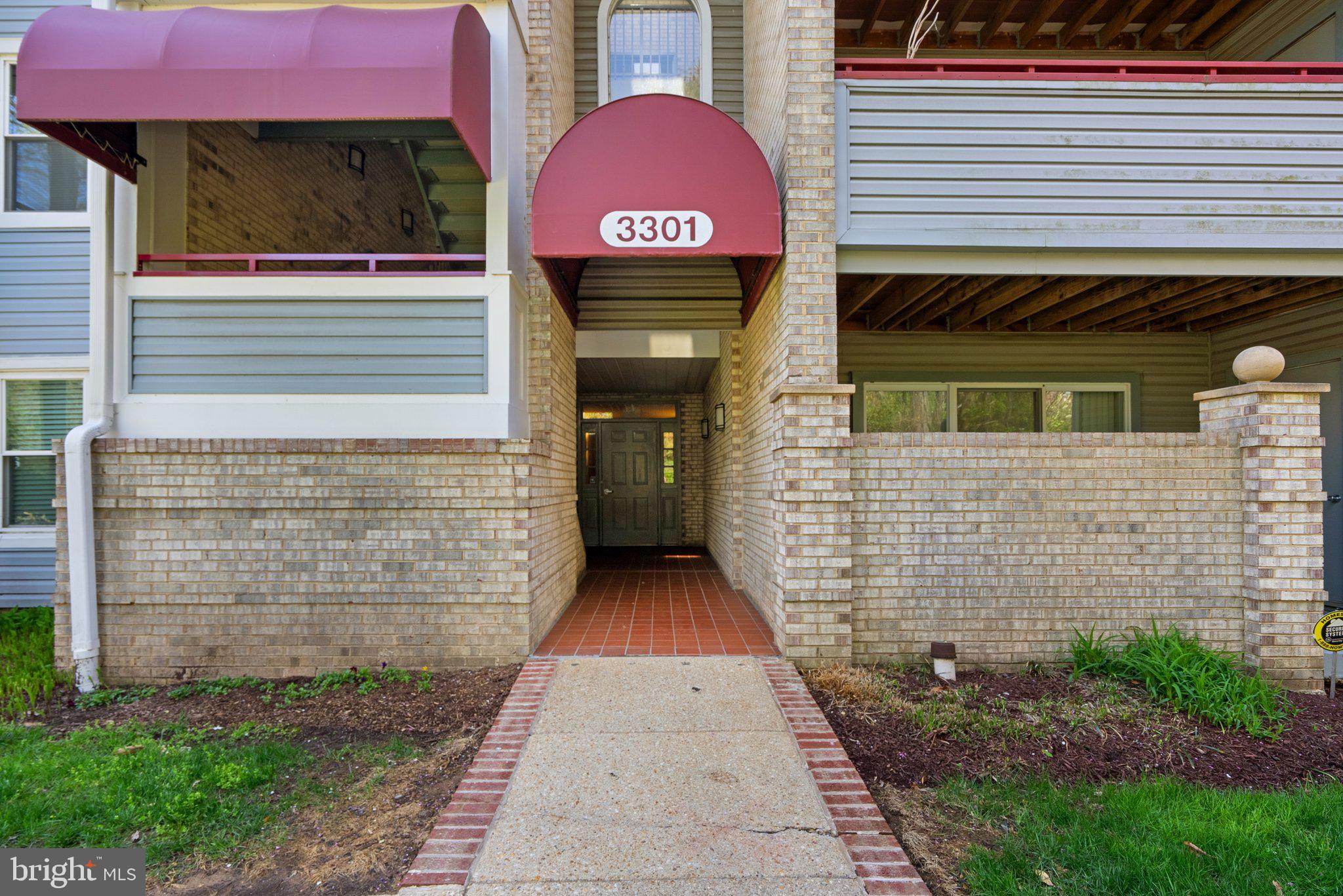 3301 Sir Thomas Drive, Unit 6B41 Silver Spring, MD 20904 - Photo 2 of 27 a front view of a house with a yard and garage