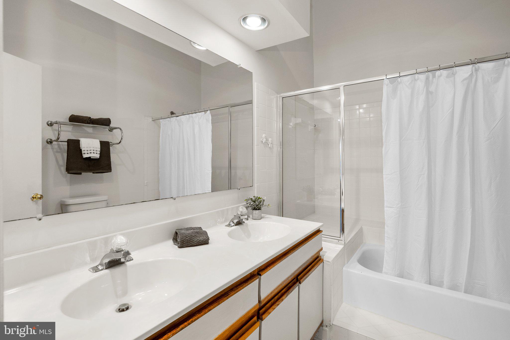 3301 Sir Thomas Drive, Unit 6B41 Silver Spring, MD 20904 - Photo 23 of 27 a bathroom with a sink and a mirror