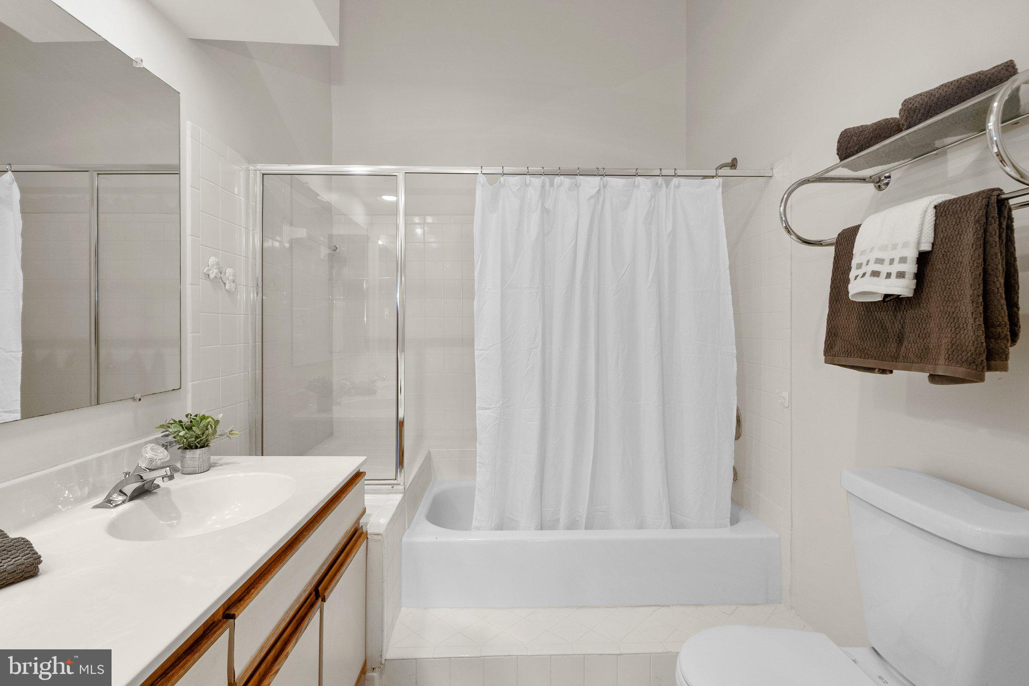 3301 Sir Thomas Drive, Unit 6B41 Silver Spring, MD 20904 - Photo 24 of 27 a bathroom with a sink a toilet and shower