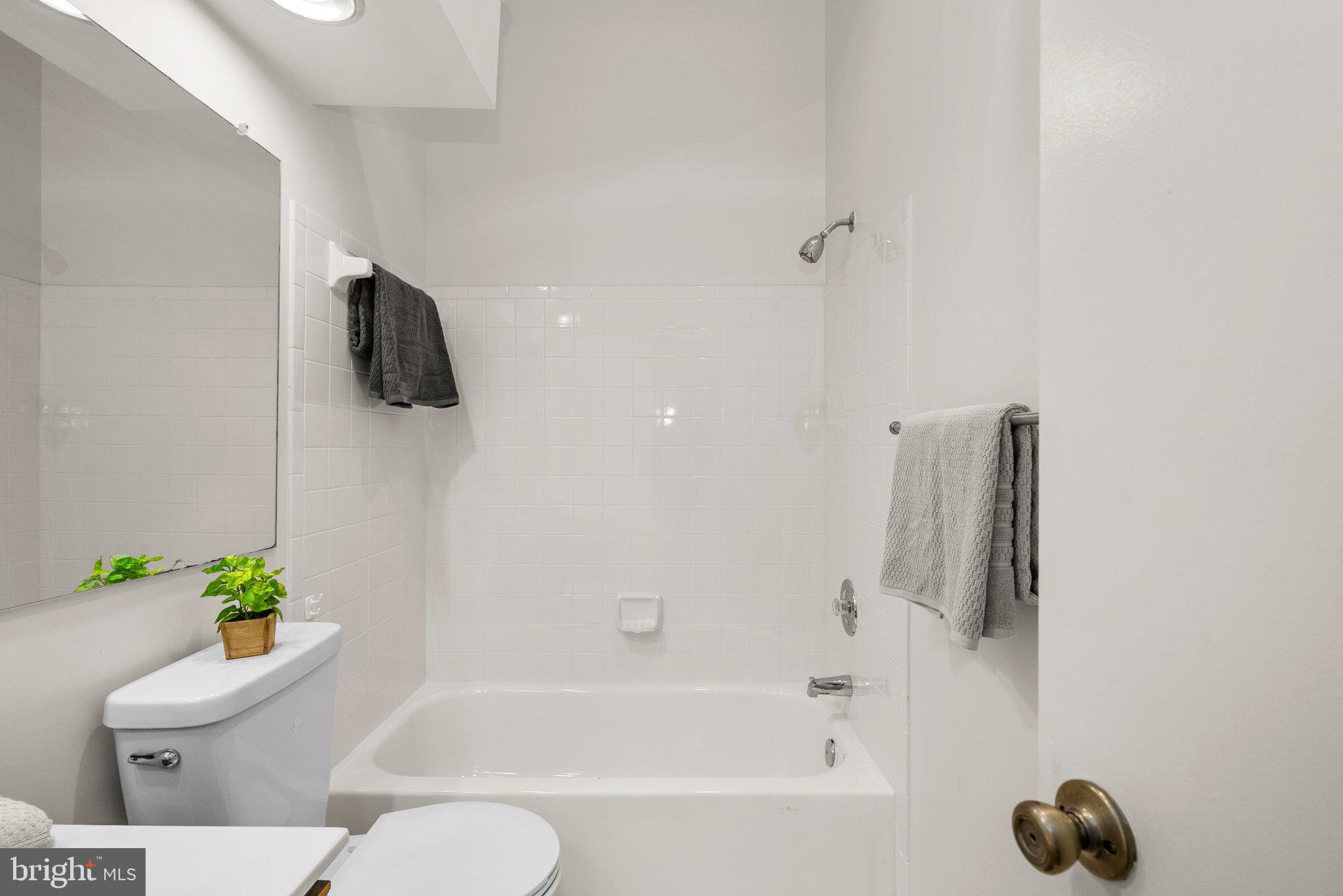 3301 Sir Thomas Drive, Unit 6B41 Silver Spring, MD 20904 - Photo 25 of 27 a white bath tub sitting next to a white toilet