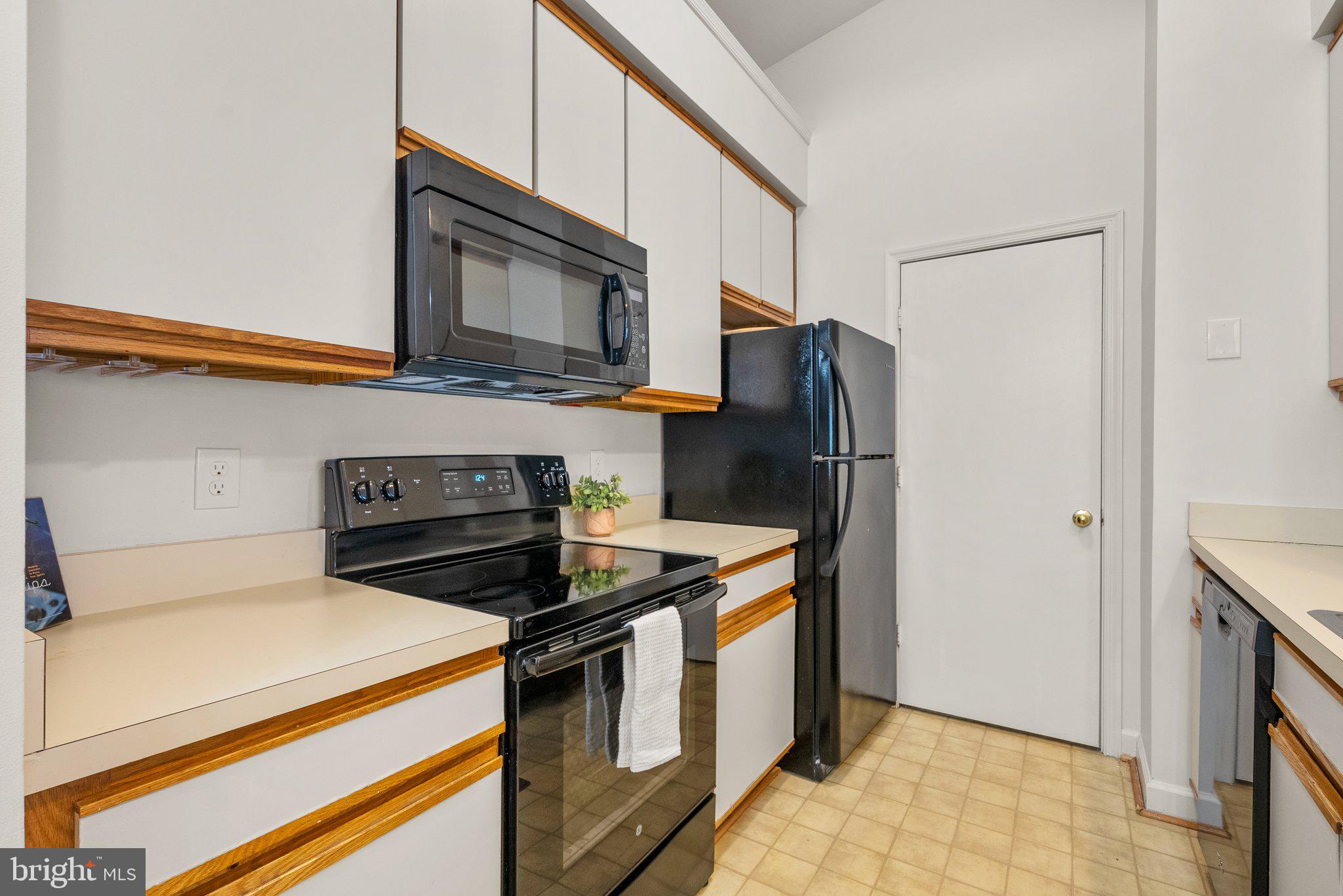 3301 Sir Thomas Drive, Unit 6B41 Silver Spring, MD 20904 - Photo 5 of 27 a kitchen with stainless steel appliances a stove microwave and refrigerator