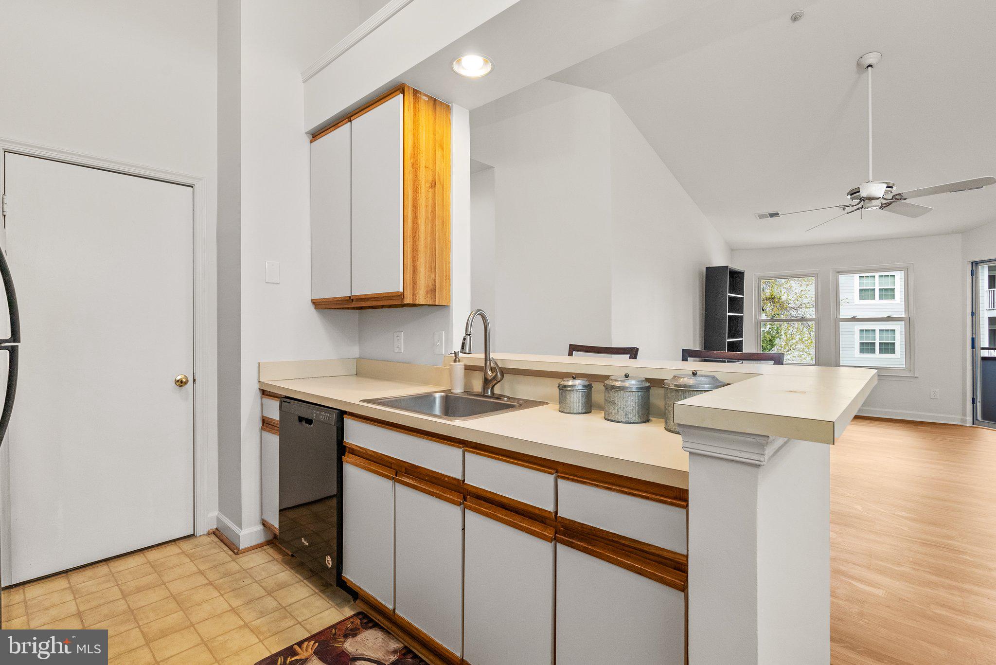 3301 Sir Thomas Drive, Unit 6B41 Silver Spring, MD 20904 - Photo 6 of 27 a kitchen with a sink cabinets and wooden floor