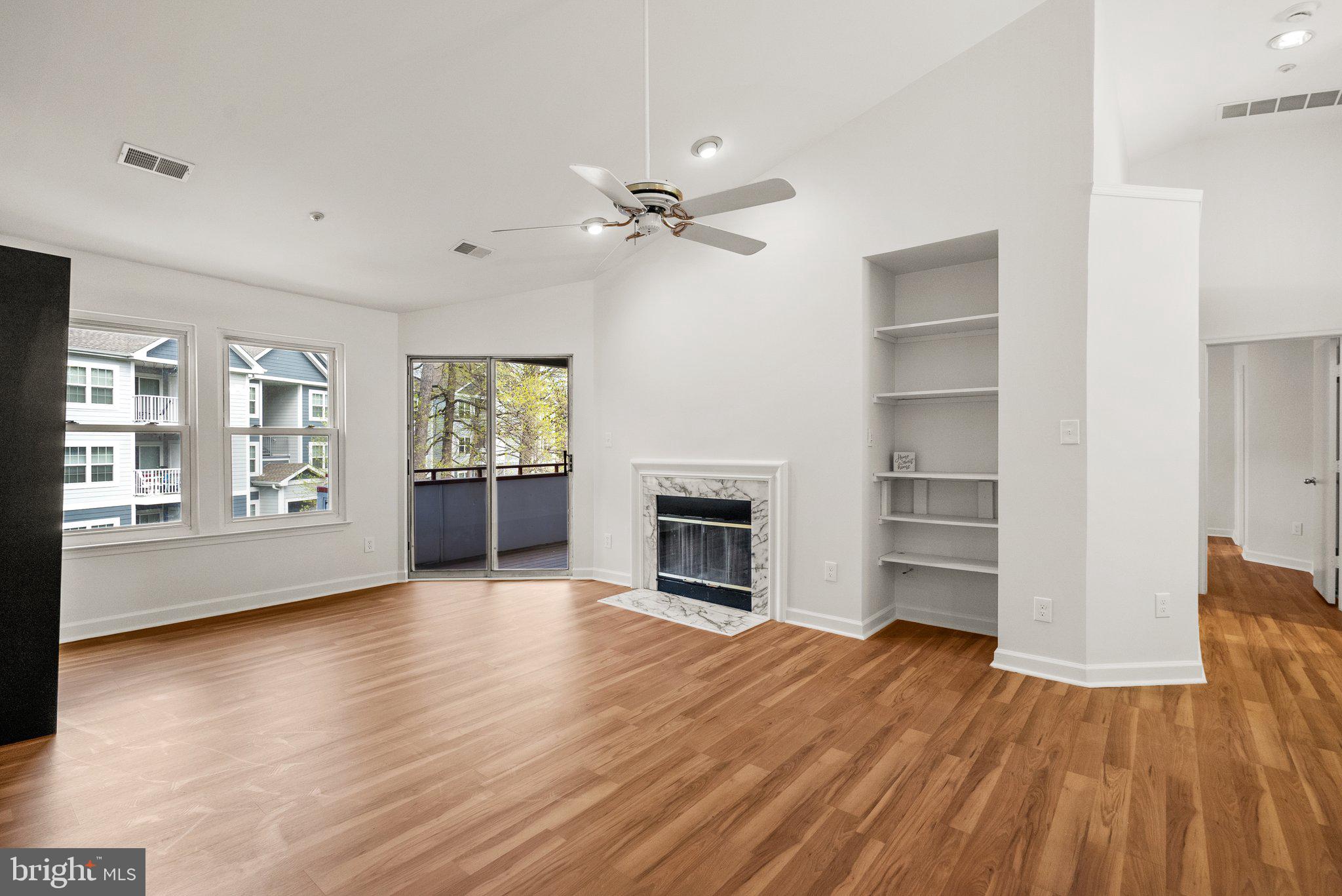 3301 Sir Thomas Drive, Unit 6B41 Silver Spring, MD 20904 - Photo 10 of 27 wooden floor fireplace and windows in a room