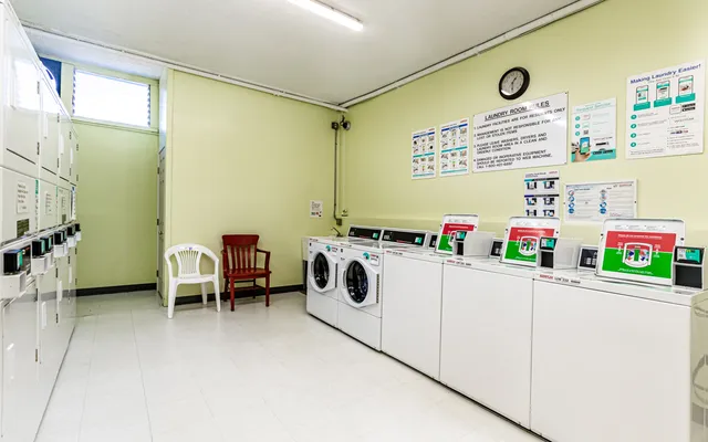a utility room with fridge dryer and washer