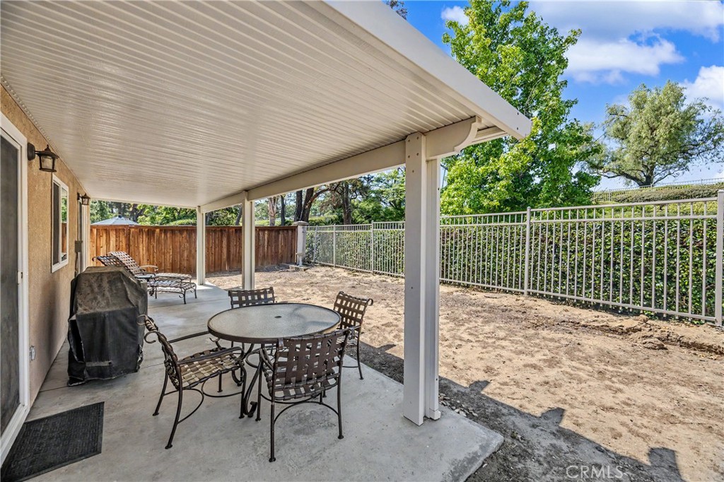 43121 Corte Cabrera Temecula, CA 92592 - Photo 14 of 17 a view of a patio with a table and chairs and a barbeque