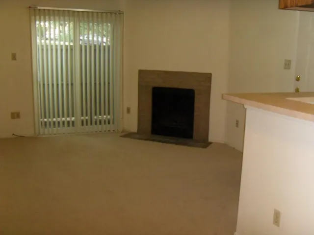 a view of an empty room with a fireplace