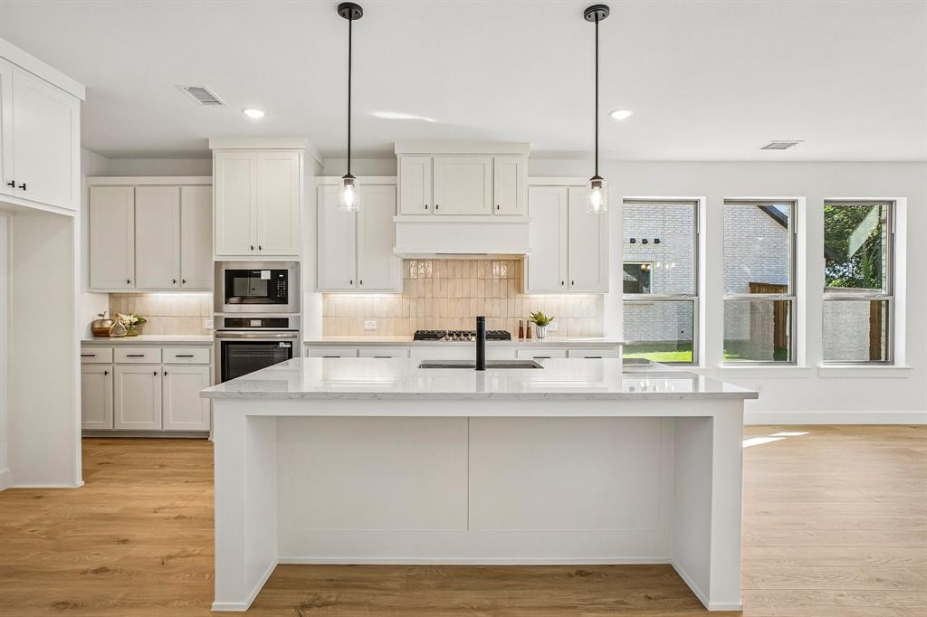 1516 Rose Mallow Road Celina, TX 75009 - Photo 8 of 22 The spacious kitchen island is the hub of your new chefs kitchen and the perfect place for friends and family to gather round!
