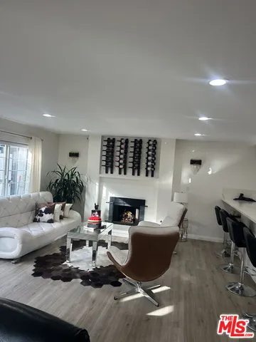 a living room with furniture wooden floor and a fireplace