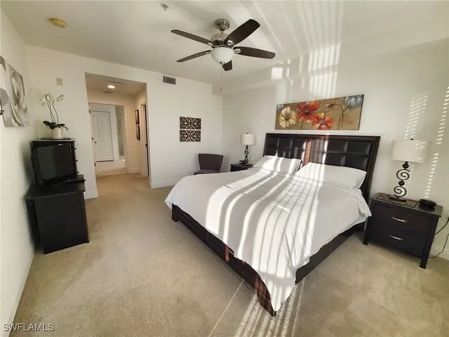 a bedroom with a bed and a television