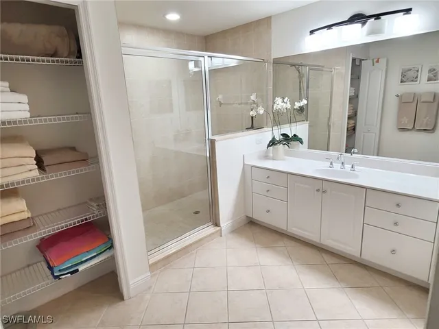 a bathroom with a shower sink and mirror