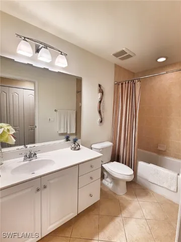 a bathroom with a double vanity sink toilet mirror and shower