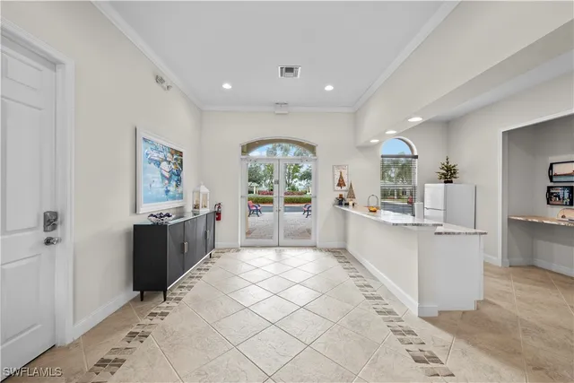 a large white kitchen with lots of counter space and windows