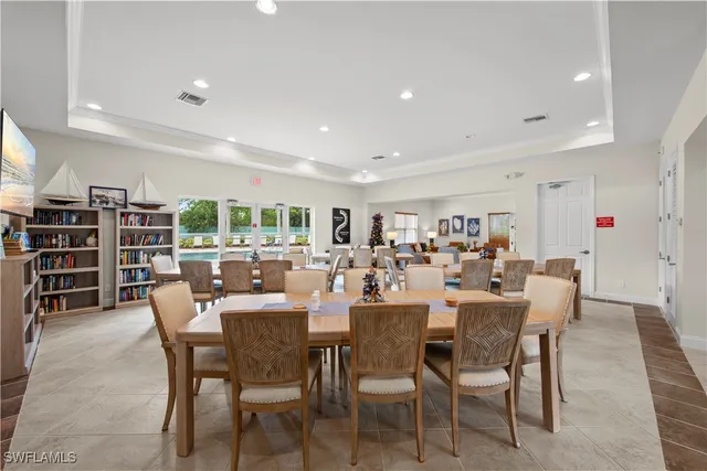a dining room with furniture a rug and a large window