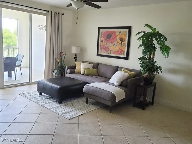 a living room with furniture and a potted plant