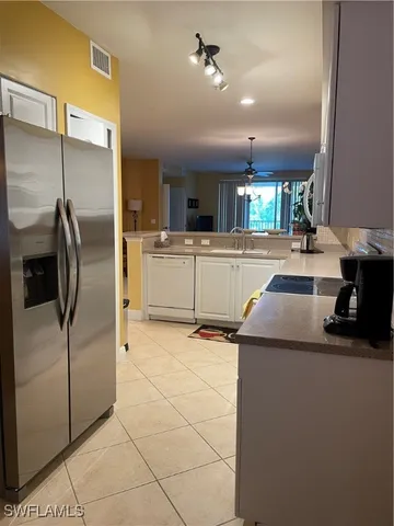 a kitchen with a refrigerator and microwave