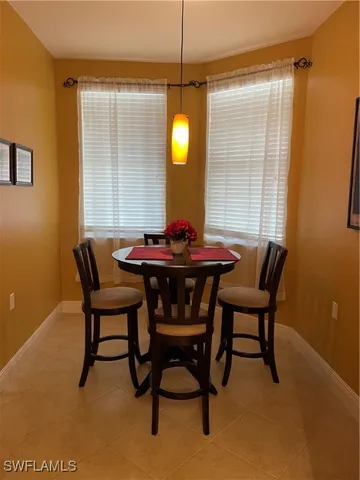 a dining room with furniture and window