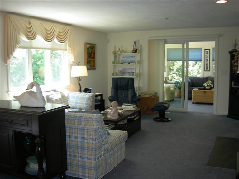 23 North Ridge Road, Unit 450 Mashpee, MA 02649 - Photo 4 of 25 a living room with furniture fireplace and a large window