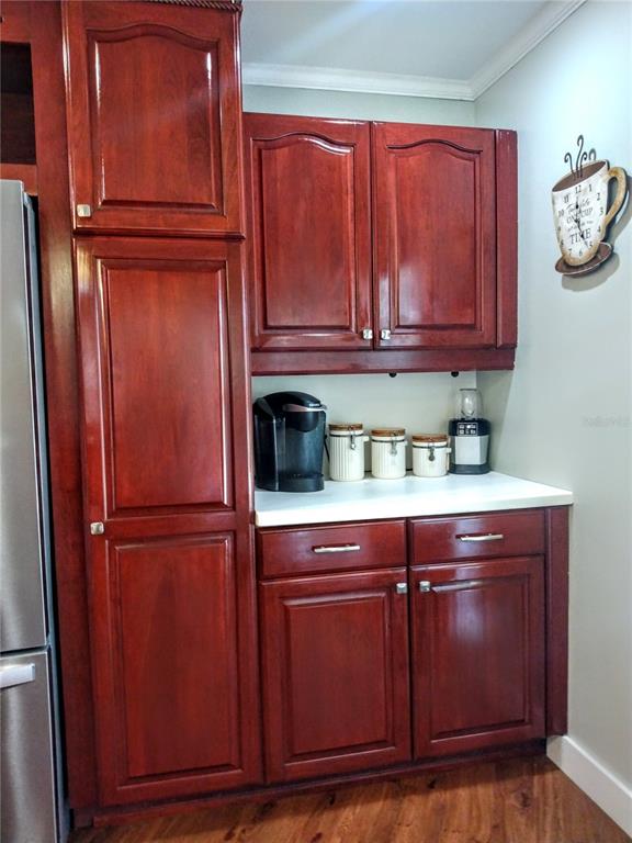 13 Gracie Road DeBary, FL 32713 - Photo 11 of 53 a kitchen with wooden cabinets and a refrigerator