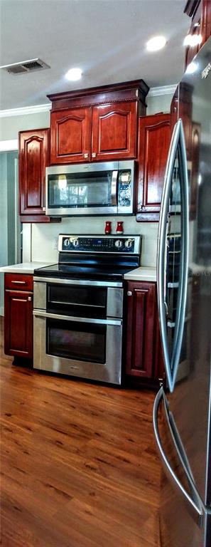 13 Gracie Road DeBary, FL 32713 - Photo 12 of 53 a kitchen with stainless steel appliances granite countertop a stove a sink and a microwave