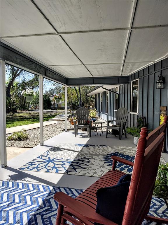 13 Gracie Road DeBary, FL 32713 - Photo 49 of 53 a view of a porch with furniture and next to a yard