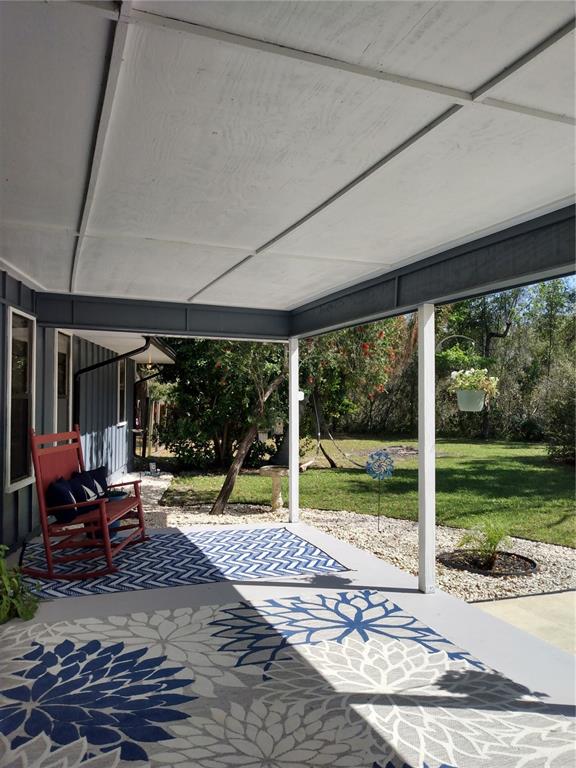 13 Gracie Road DeBary, FL 32713 - Photo 51 of 53 a view of a patio with table and chairs near a yard