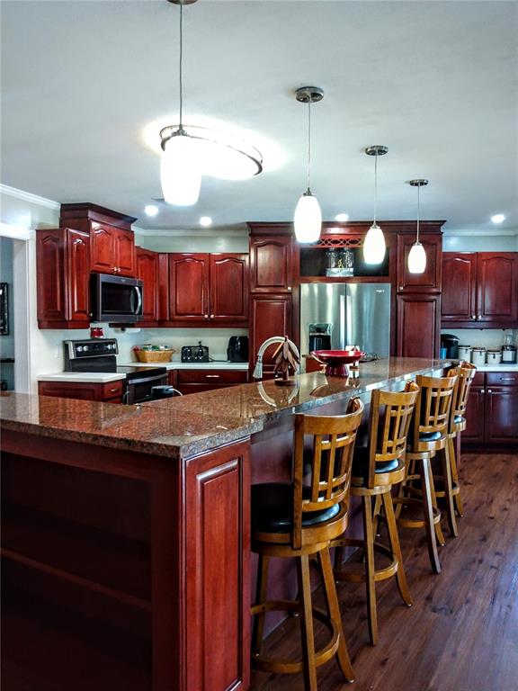 13 Gracie Road DeBary, FL 32713 - Photo 10 of 53 a kitchen with stainless steel appliances lots of wooden furniture