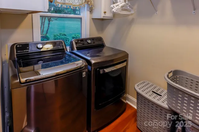 a living room with furniture piano and a chandelier