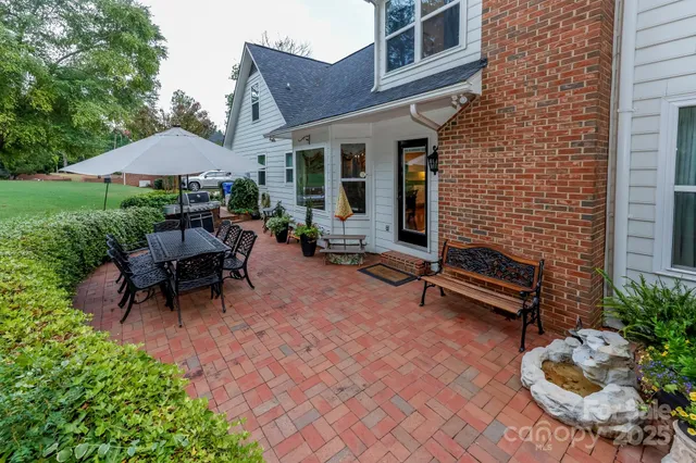 a backyard of a house with outdoor seating