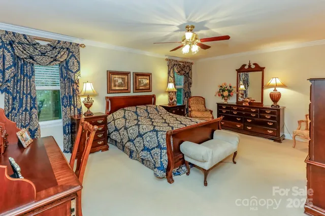 a bedroom with furniture and a chandelier