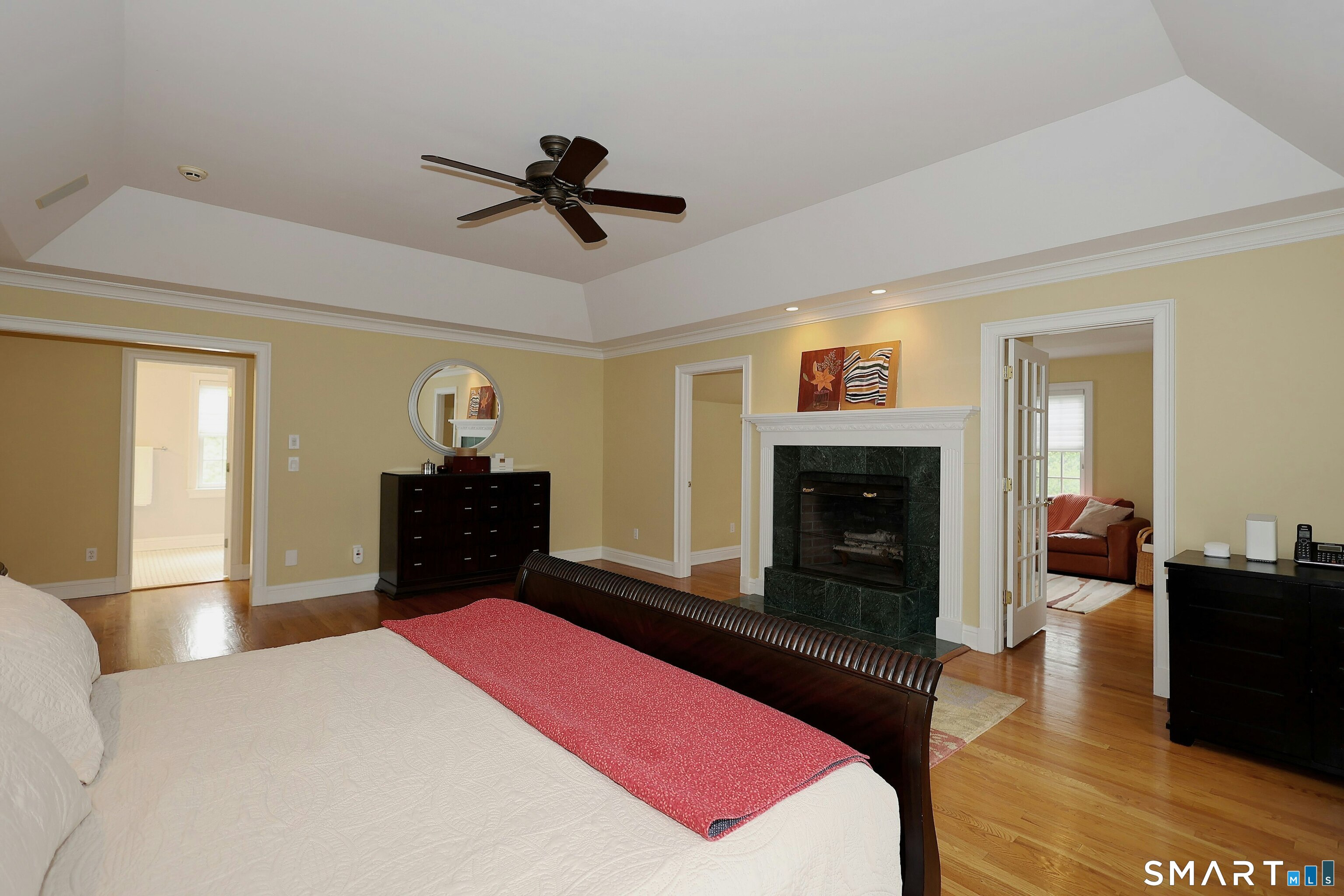 30 Whipstick Road Ridgefield, CT 06877 - Photo 29 of 40 a bedroom with a bed and a chandelier