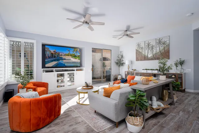 a living room with furniture kitchen view and a window