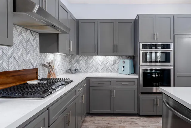 a kitchen with kitchen island granite countertop a stove and a sink