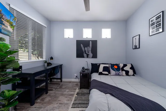 a bedroom with furniture and a potted plant