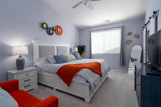 a bedroom with a bed and a television