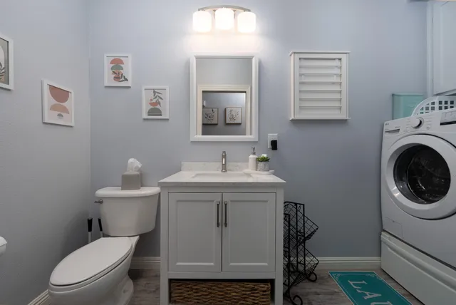 a utility room with sink dryer and washer