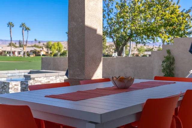 a view of a patio with couches chairs and a potted plant