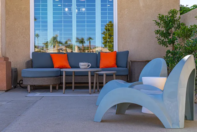 an outdoor space with patio furniture and wooden floor