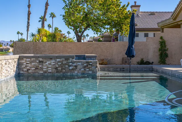 a view of a swimming pool with a patio