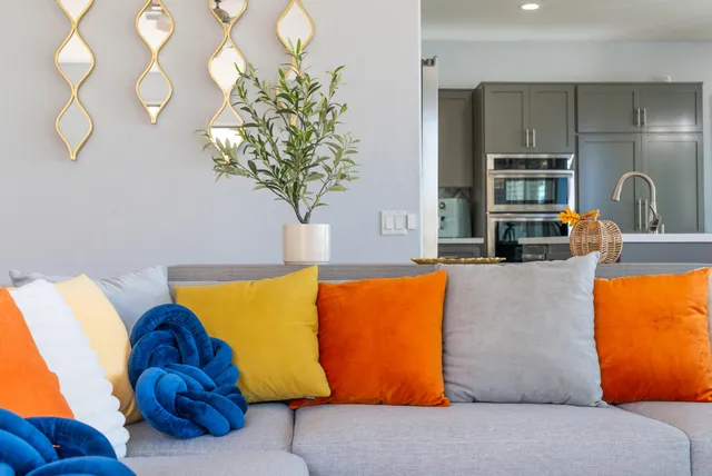 a living room with furniture potted plant and a large window