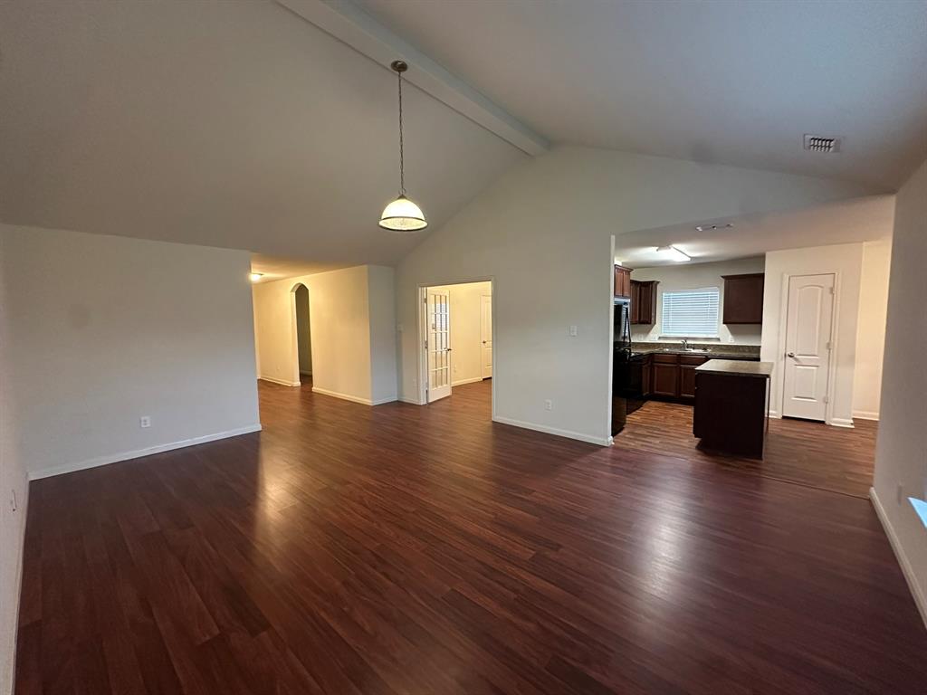 1818 Clegg Street Howe, TX 75459 - Photo 27 of 34 Expansive main living area featuring vaulted ceilings, wood-finish flooring, and an open concept layout