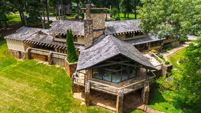 a view of a wooden bridge with a yard