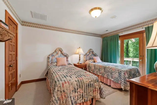 an aerial view of residential house with outdoor space and trees all around