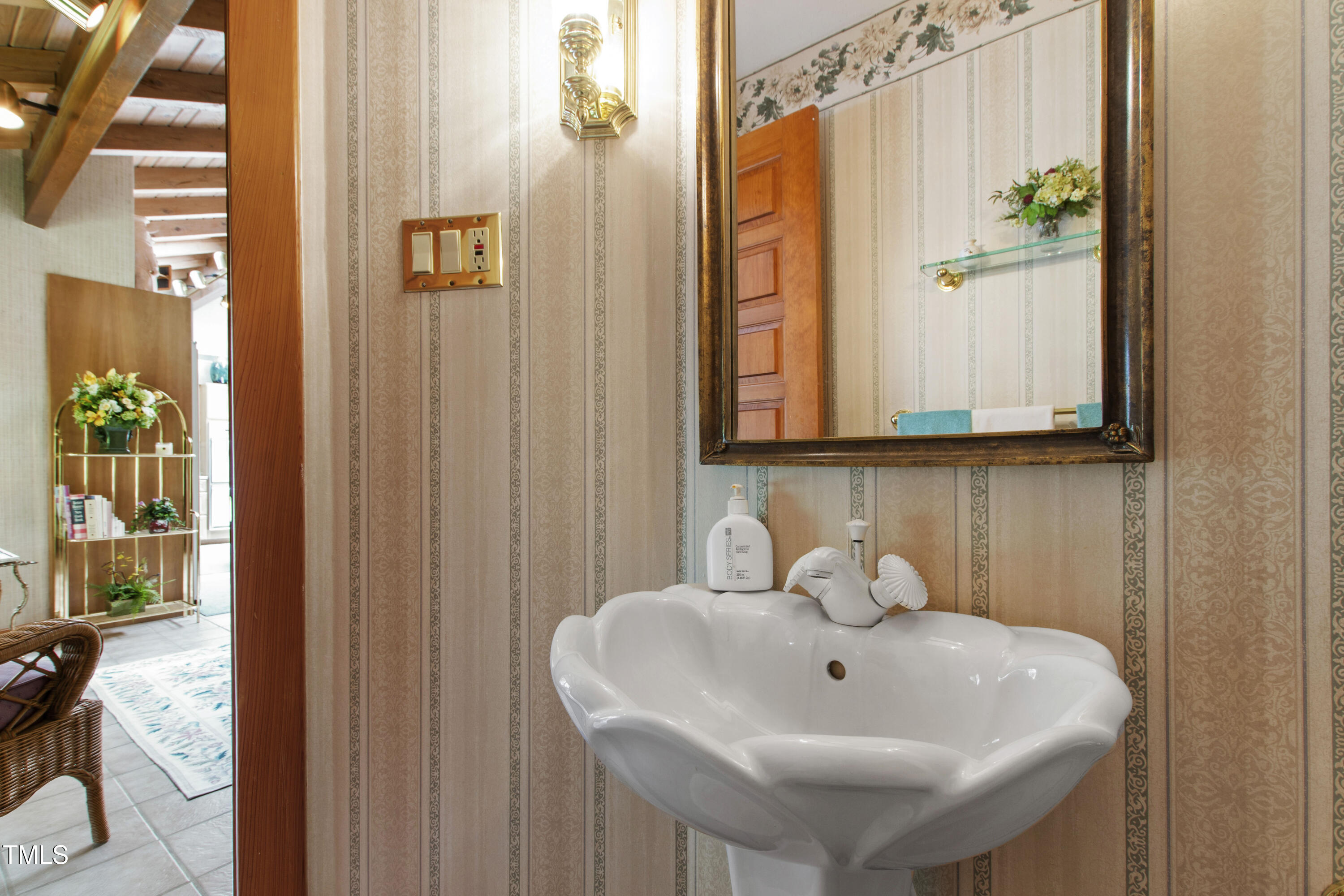 812 Kenmore Road Chapel Hill, NC 27514 - Photo 29 of 95 a bathroom with a sink a mirror and a window
