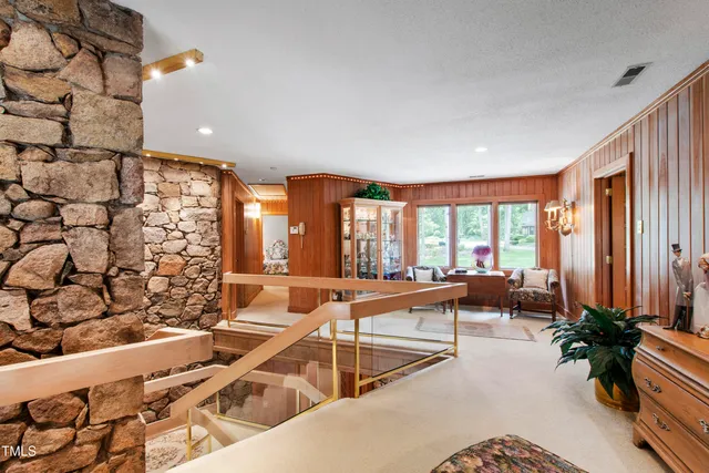 a living room with furniture ceiling fan and a rug