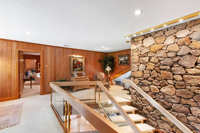 a living room with furniture a flat screen tv and a large window
