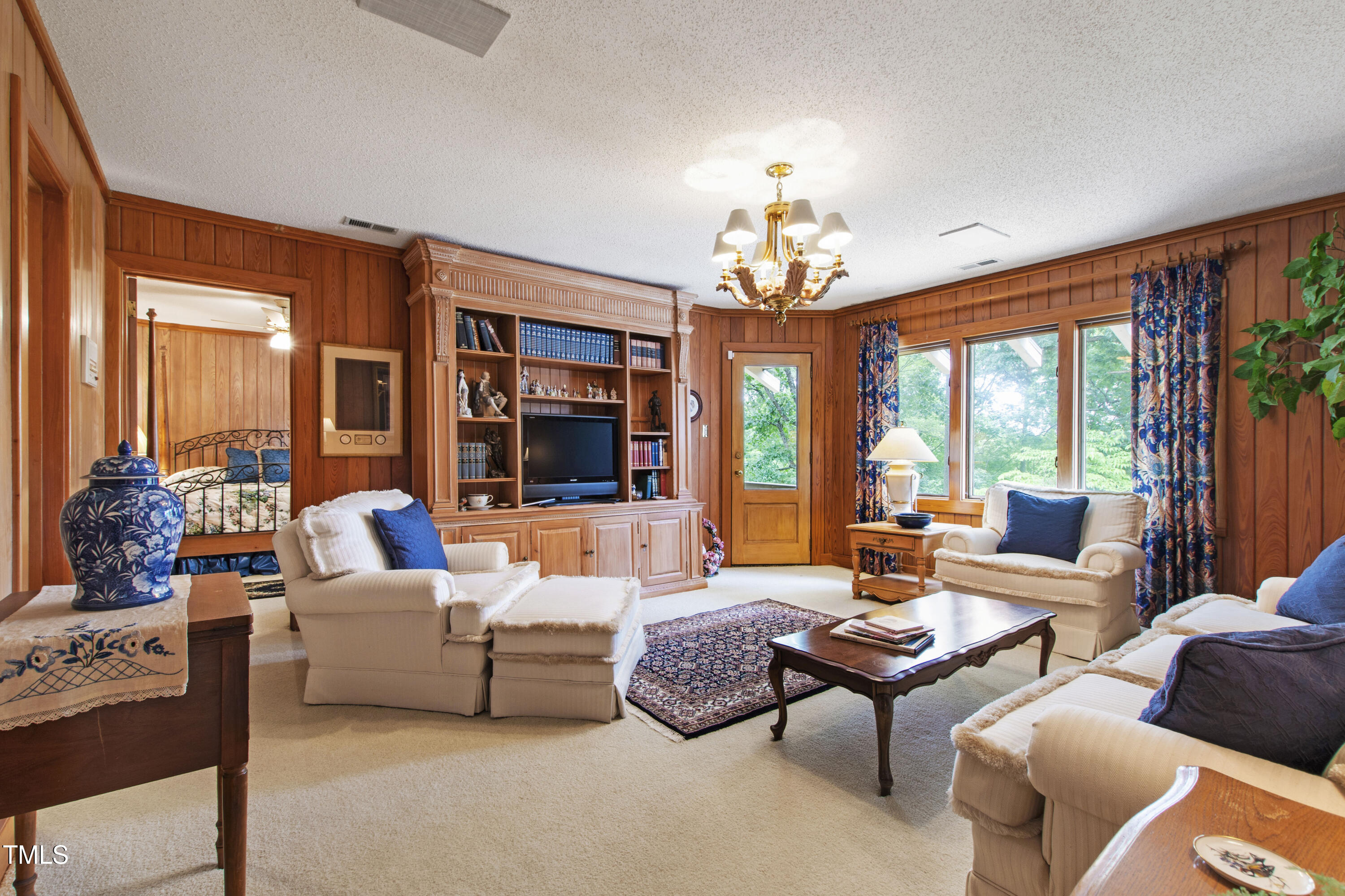 812 Kenmore Road Chapel Hill, NC 27514 - Photo 36 of 95 a living room with furniture chandelier and a large window