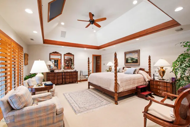 a view of a house with a yard and large tree