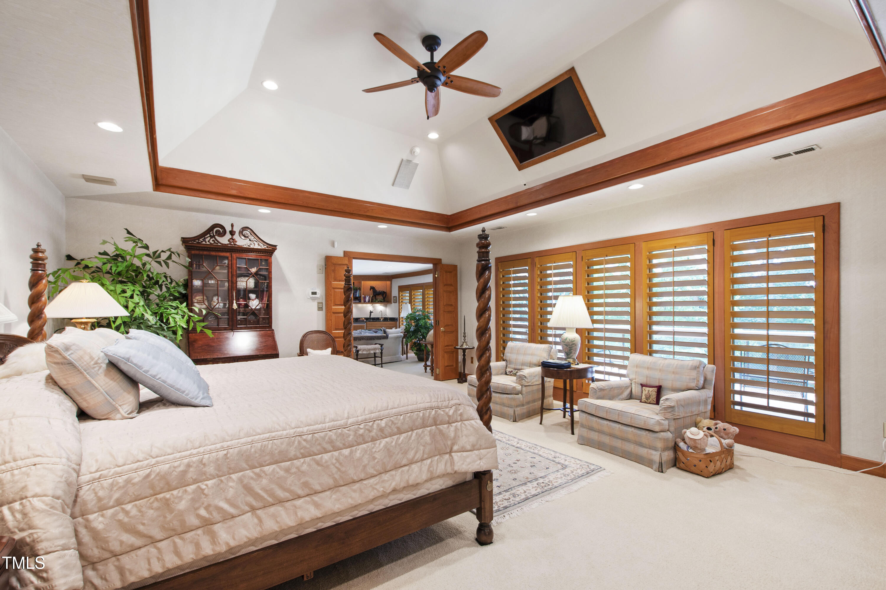 812 Kenmore Road Chapel Hill, NC 27514 - Photo 45 of 95 a spacious bedroom with a bed a couch and a ceiling fan