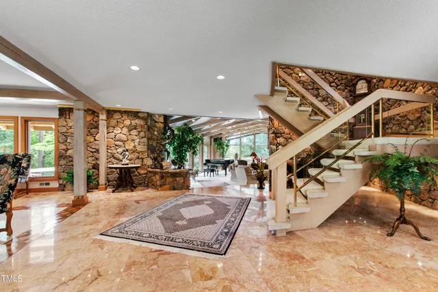 a living room with furniture fireplace and flat screen tv