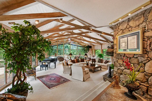 a front view of a house with a yard table and outdoor seating